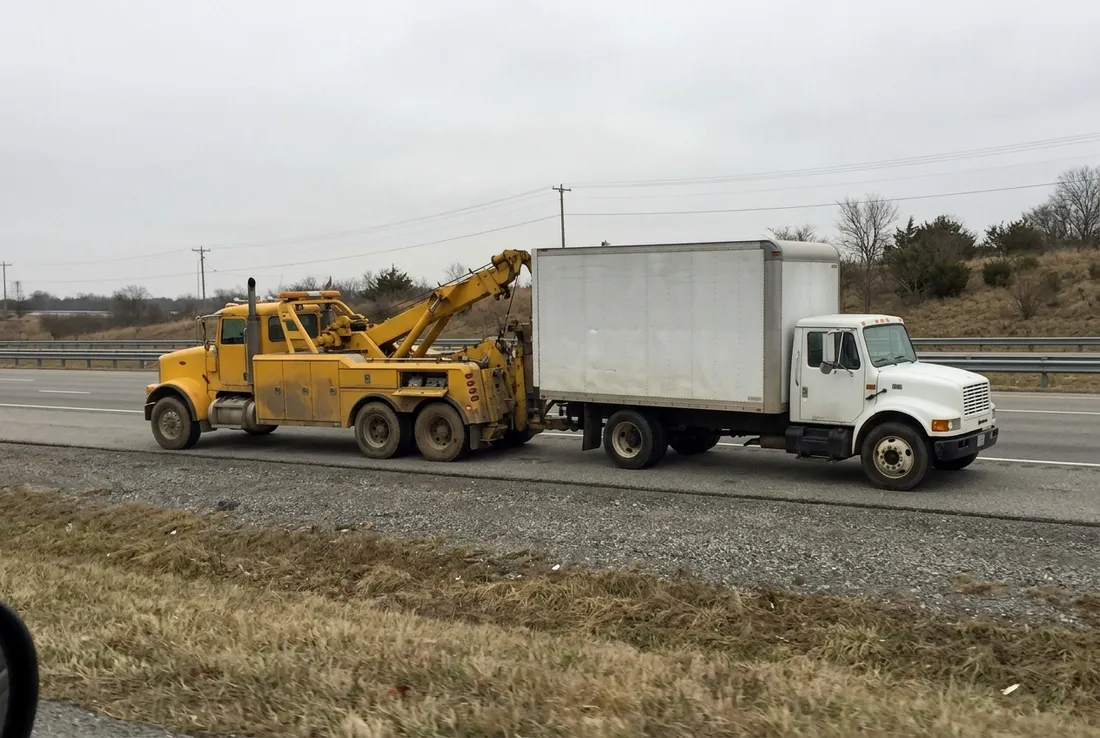 Heavy-duty wrecker towing a box truck near Georgetown, TX